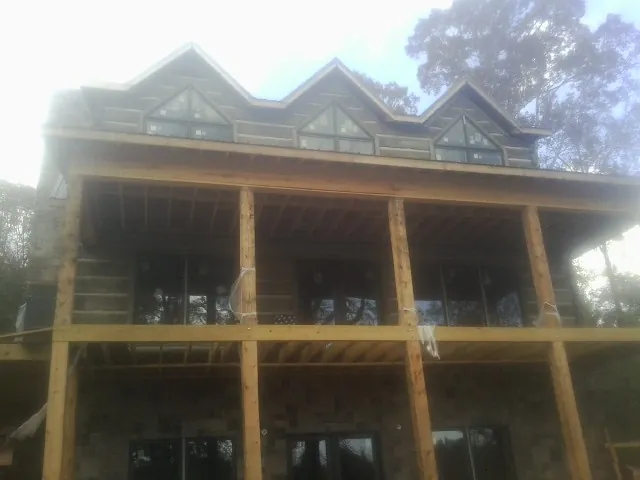 Dormers and porch framing on a large log home under construction in Gladstone